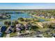 Aerial view of a beautiful home on a waterfront lot with stunning lake views at 31028 Baclan Dr, Wesley Chapel, FL 33545