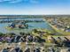 Aerial view of beautiful homes on waterfront lots with stunning lake views and community park at 31028 Baclan Dr, Wesley Chapel, FL 33545