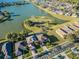 Aerial view of beautiful homes on waterfront lots with stunning lake views and community park at 31028 Baclan Dr, Wesley Chapel, FL 33545
