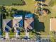 An aerial view of homes with manicured lawns, driveways, and screened pools in a neighborhood at 31028 Baclan Dr, Wesley Chapel, FL 33545