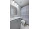 Bathroom featuring double sink vanity, shower with grey patterned curtain and bright lighting at 31028 Baclan Dr, Wesley Chapel, FL 33545