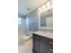 A well-maintained bathroom with gray walls, white marble countertop and white tiled shower at 31028 Baclan Dr, Wesley Chapel, FL 33545