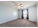 Bright bedroom with ceiling fan and a window dressed with curtains, creating a soothing ambiance at 31028 Baclan Dr, Wesley Chapel, FL 33545