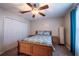 Charming bedroom featuring a ceiling fan and a double closet for ample storage solutions at 31028 Baclan Dr, Wesley Chapel, FL 33545