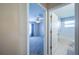 A look at the bedroom with ceiling fan as seen from hallway featuring the bathroom to the right at 31028 Baclan Dr, Wesley Chapel, FL 33545
