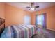 Bedroom with neutral carpet and a ceiling fan, featuring a window with blinds at 31028 Baclan Dr, Wesley Chapel, FL 33545