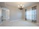 Bright dining room featuring an elegant chandelier, marble flooring, and neutral paint at 31028 Baclan Dr, Wesley Chapel, FL 33545