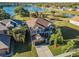 Lovely two-story home features a manicured lawn, mature palms, and stunning lake views at 31028 Baclan Dr, Wesley Chapel, FL 33545