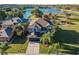 Lovely two-story home features a manicured lawn, mature palms, and stunning lake views at 31028 Baclan Dr, Wesley Chapel, FL 33545