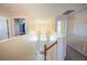 Upstairs foyer featuring a view of the downstairs front door and an abundance of natural light at 31028 Baclan Dr, Wesley Chapel, FL 33545