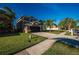 View of well maintained lawn and sidewalk leading up to a 2-story home with an attached garage at 31028 Baclan Dr, Wesley Chapel, FL 33545