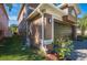 Side view of home showcasing a dark brown garage door and lush green grass at 31028 Baclan Dr, Wesley Chapel, FL 33545