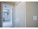 Hallway view leading to a bathroom featuring tiled floors and a white vanity at 31028 Baclan Dr, Wesley Chapel, FL 33545