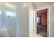 Hallway with view into bedroom with neutral paint and white trim at 31028 Baclan Dr, Wesley Chapel, FL 33545
