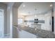 A partial kitchen view highlighting granite countertops, an island, and stainless steel appliances at 31028 Baclan Dr, Wesley Chapel, FL 33545