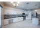 Open kitchen with white cabinets, granite counters, stainless appliances, and stylish tile backsplash at 31028 Baclan Dr, Wesley Chapel, FL 33545