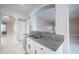 A close view into the kitchen reveals granite countertops and undermount sink at 31028 Baclan Dr, Wesley Chapel, FL 33545