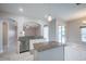 Kitchen featuring a functional island with granite countertop, stainless steel appliances, and tile floors at 31028 Baclan Dr, Wesley Chapel, FL 33545