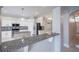 This kitchen has granite counters, white cabinets, stainless steel appliances, and an island at 31028 Baclan Dr, Wesley Chapel, FL 33545
