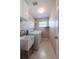 Functional laundry room with washer, dryer, wash tub, and practical shelving at 31028 Baclan Dr, Wesley Chapel, FL 33545