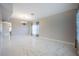 Spacious living room with marble floors, neutral paint, chandelier, and an open layout at 31028 Baclan Dr, Wesley Chapel, FL 33545
