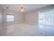 Bright living room featuring modern marble floors, a ceiling fan, and a sliding glass door at 31028 Baclan Dr, Wesley Chapel, FL 33545
