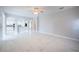 Open concept living room featuring marble floors and arched entryway to a white kitchen at 31028 Baclan Dr, Wesley Chapel, FL 33545