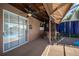 Screened-in patio area with an outdoor kitchen and seating with a pool view at 31028 Baclan Dr, Wesley Chapel, FL 33545