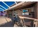 Patio area with an outdoor kitchen and seating, with a pool view at 31028 Baclan Dr, Wesley Chapel, FL 33545