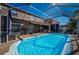 A private screened-in pool area with covered patio and access to the home's interior at 31028 Baclan Dr, Wesley Chapel, FL 33545