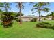 Beautifully landscaped backyard with mature trees and lush greenery, offering a private oasis at 4337 Marine Pkwy, New Port Richey, FL 34652