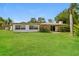 Expansive backyard with lush green grass and mature trees, ideal for outdoor enjoyment at 4337 Marine Pkwy, New Port Richey, FL 34652