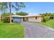 Charming single-story home with a well-maintained lawn, long driveway, and welcoming curb appeal at 4337 Marine Pkwy, New Port Richey, FL 34652