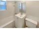 Simple bathroom featuring tile walls and floors, a single vanity, and tub/shower at 120 W Wildwood St, Tampa, FL 33613