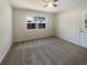 Clean bedroom with a ceiling fan, bright window, and neutral carpet at 120 W Wildwood St, Tampa, FL 33613