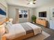 Bright bedroom featuring a ceiling fan, television, and a large window with natural light at 120 W Wildwood St, Tampa, FL 33613