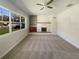 Light-filled living room features a fireplace, ceiling fan, and a large window at 120 W Wildwood St, Tampa, FL 33613