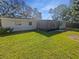 Exterior view of backyard with screened lanai at 1848 Redcoat Ln, Clearwater, FL 33764