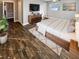 Serene main bedroom with warm floors, natural light and stylish furnishings at 1848 Redcoat Ln, Clearwater, FL 33764