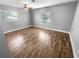 Bedroom with laminate floors, ceiling fan, and neutral walls at 1848 Redcoat Ln, Clearwater, FL 33764