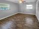 Bedroom with laminate floors, ceiling fan, and neutral walls at 1848 Redcoat Ln, Clearwater, FL 33764