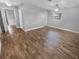 Large, bright bedroom featuring wood-look floors, ceiling fan, and neutral decor at 1848 Redcoat Ln, Clearwater, FL 33764
