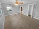 Bedroom with neutral carpet, ceiling fan, and closet at 1848 Redcoat Ln, Clearwater, FL 33764