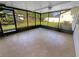 Screened porch with tan tile and view of backyard at 1848 Redcoat Ln, Clearwater, FL 33764