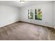 Clean, empty bedroom with neutral carpet and a bright window at 2405 Burlwood Dr, Lutz, FL 33549