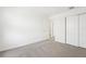 A neutral bedroom with carpeting and an open doorway at 31653 Wild Grape Ln, Brooksville, FL 34602