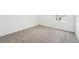 Bright, carpeted bedroom featuring neutral tones and natural light at 31653 Wild Grape Ln, Brooksville, FL 34602