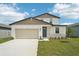 Charming two-story home featuring a 2-car garage, stone accents, and a well-manicured lawn at 31653 Wild Grape Ln, Brooksville, FL 34602