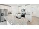 Bright kitchen featuring granite countertops, stainless steel appliances, and white cabinetry at 31653 Wild Grape Ln, Brooksville, FL 34602
