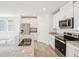 Modern kitchen featuring granite countertops, stainless steel appliances, and ample white cabinetry at 31653 Wild Grape Ln, Brooksville, FL 34602